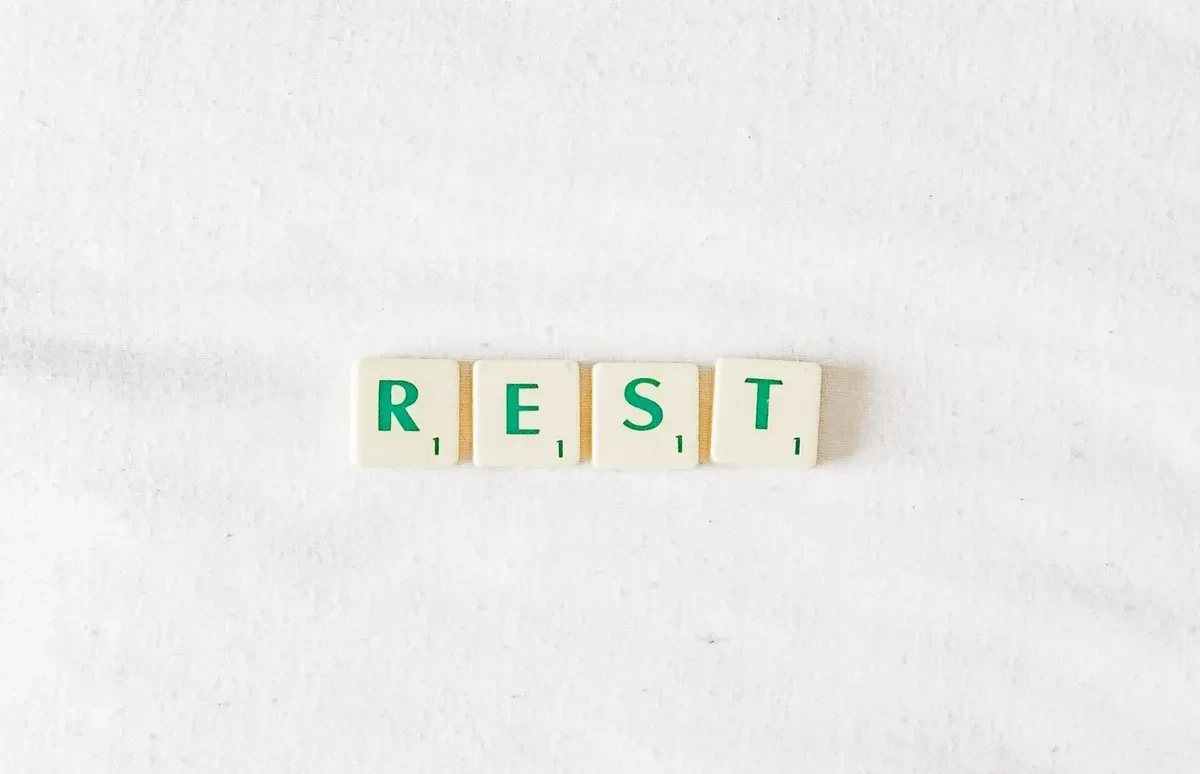 Tile that spells out 'rest' on a white background