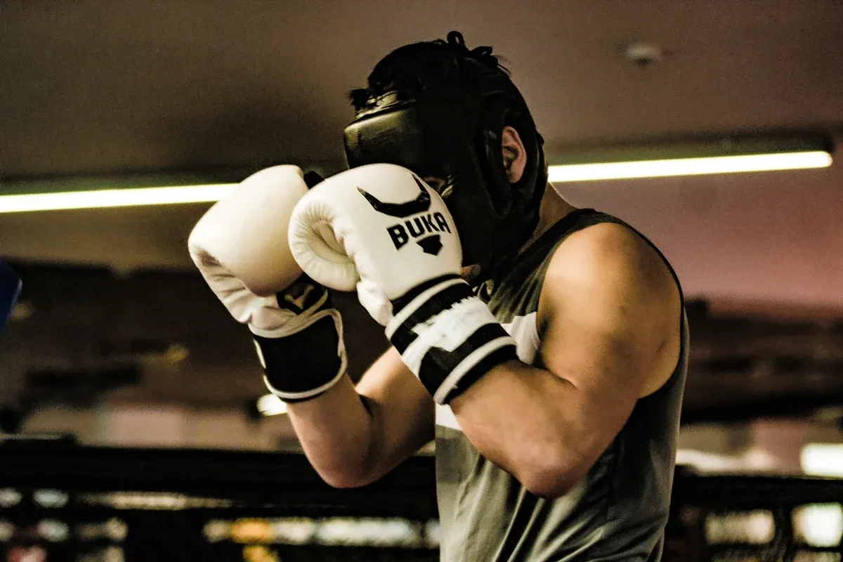 A man wearing boxing gear in a boxing ring