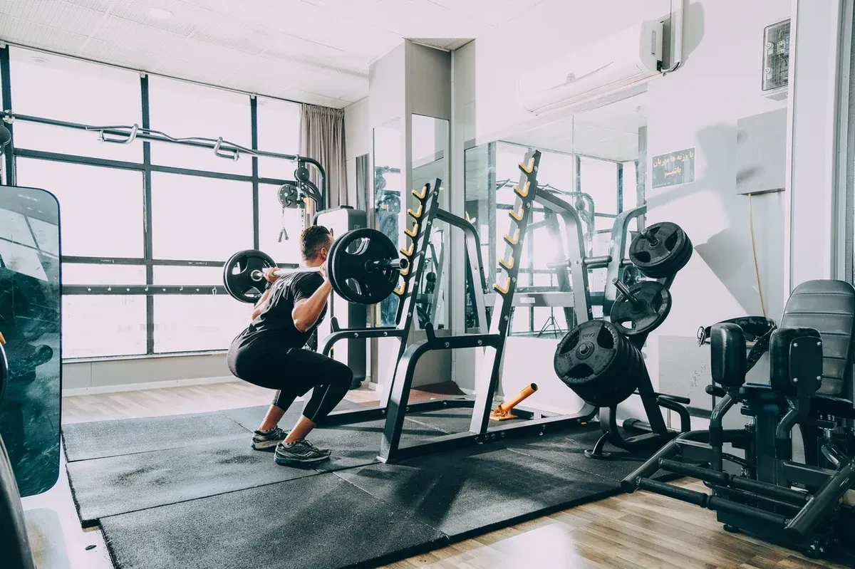 Man working out in a gym, lifting weights