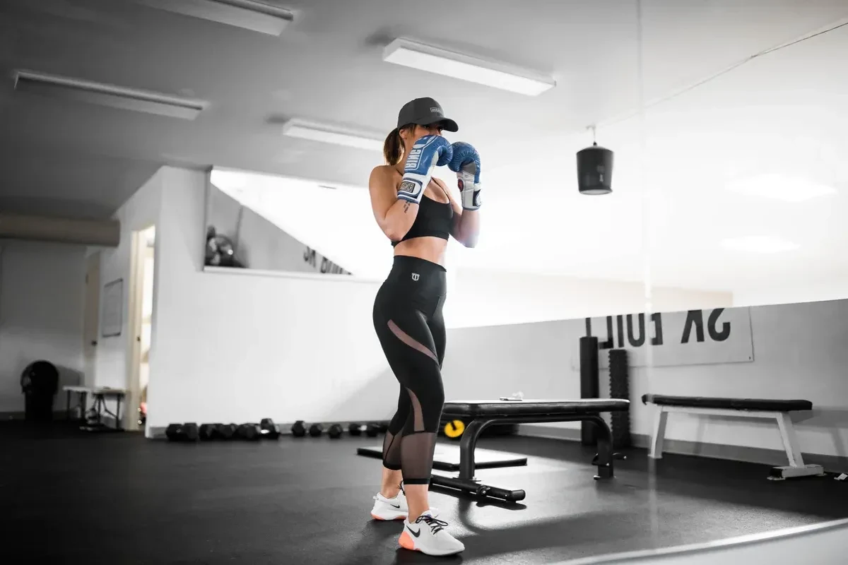 Female trainer in the gym getting ready to practice kickboxing
