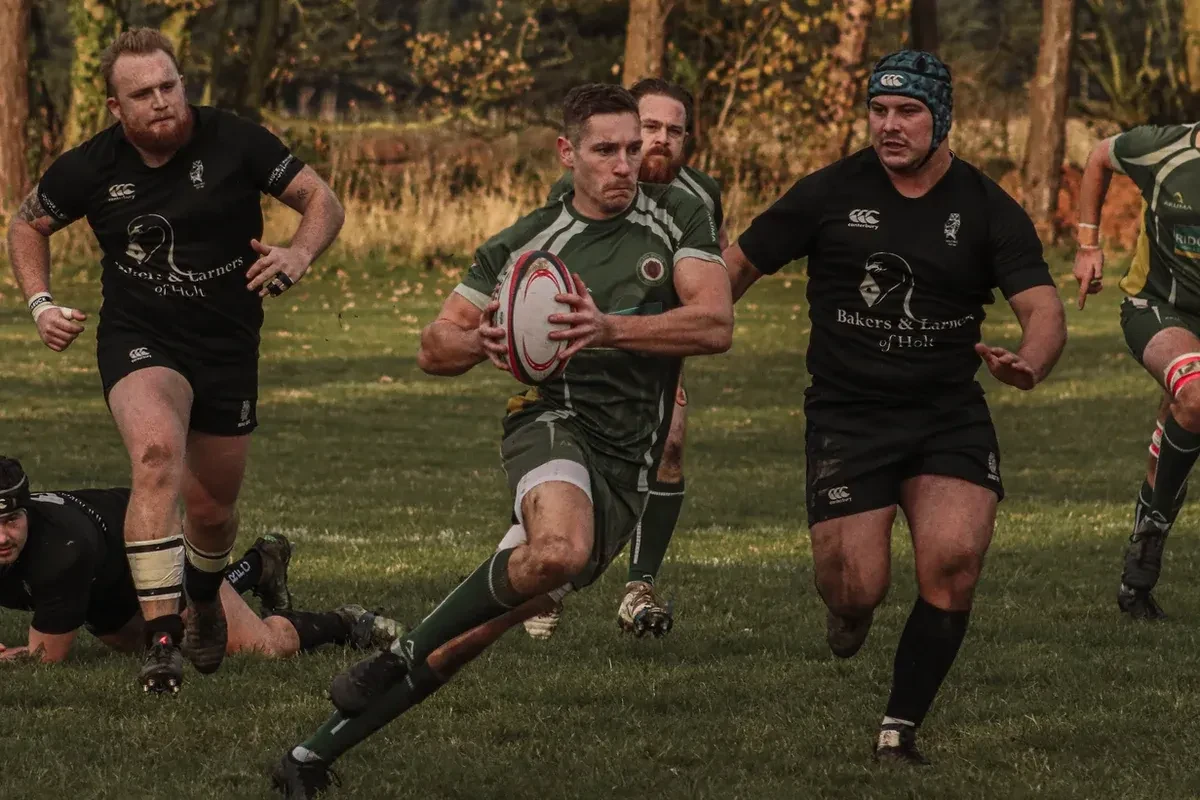 A group of male athletes playing rugby