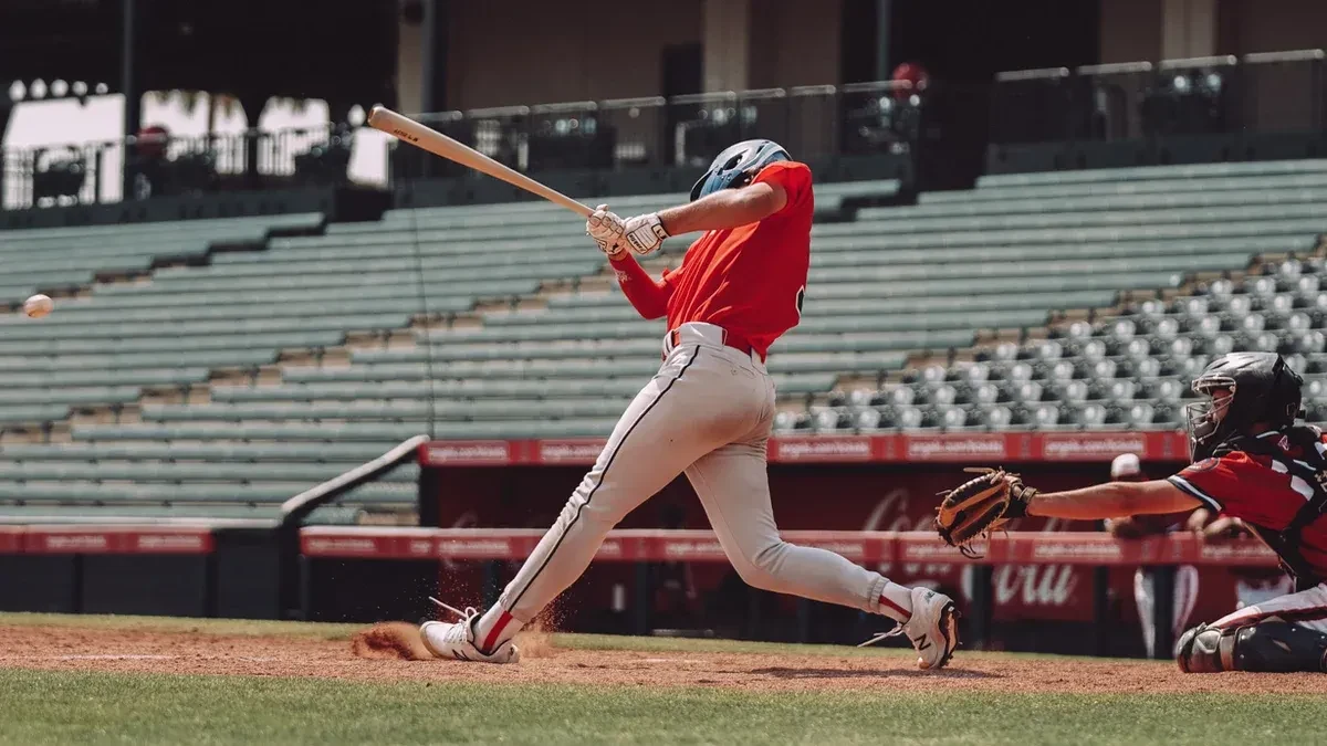 A baseball player powerfully swinging a bat, showcasing the explosive energy fueled by consistent athletic habits.