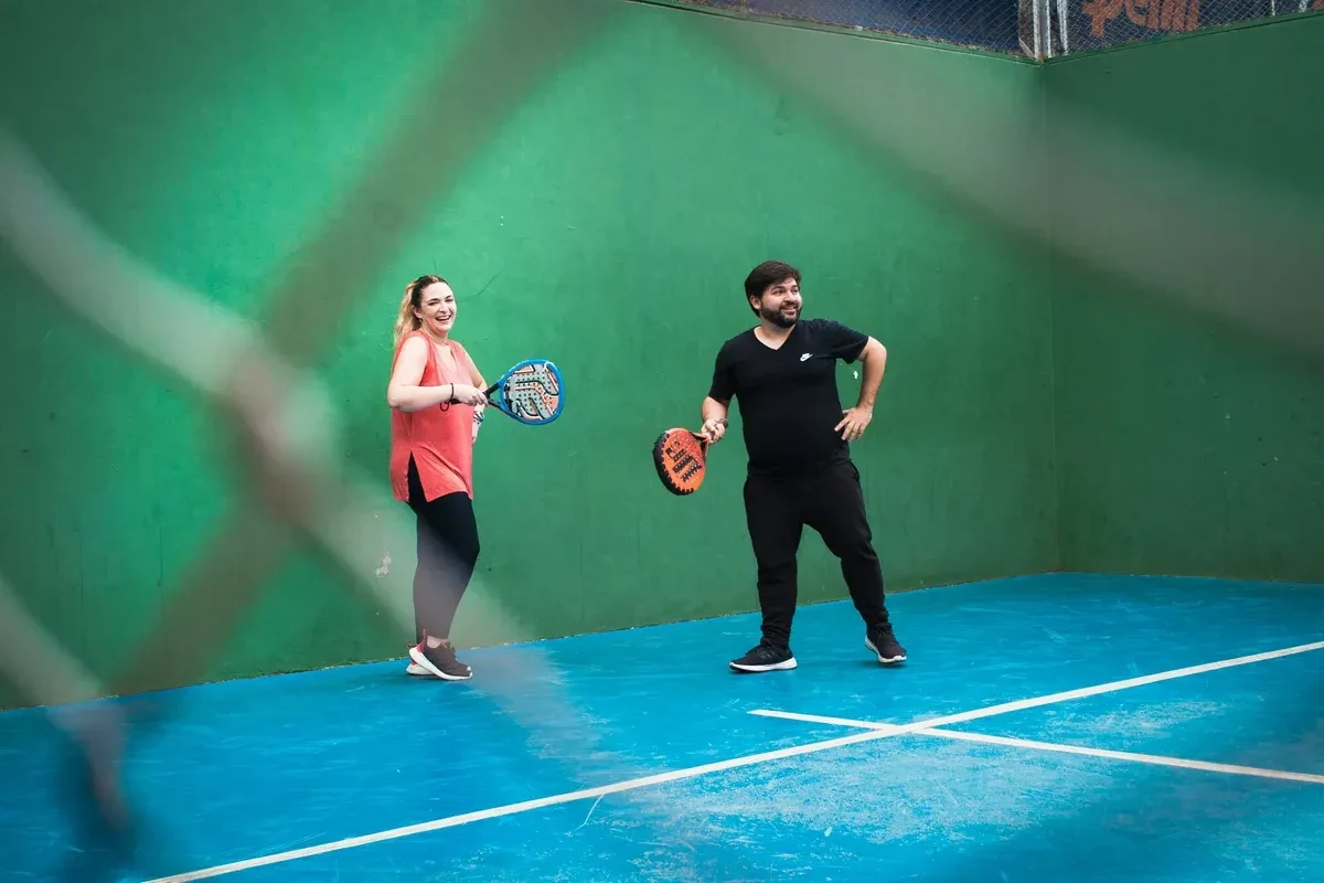 Two friends playing squash outside