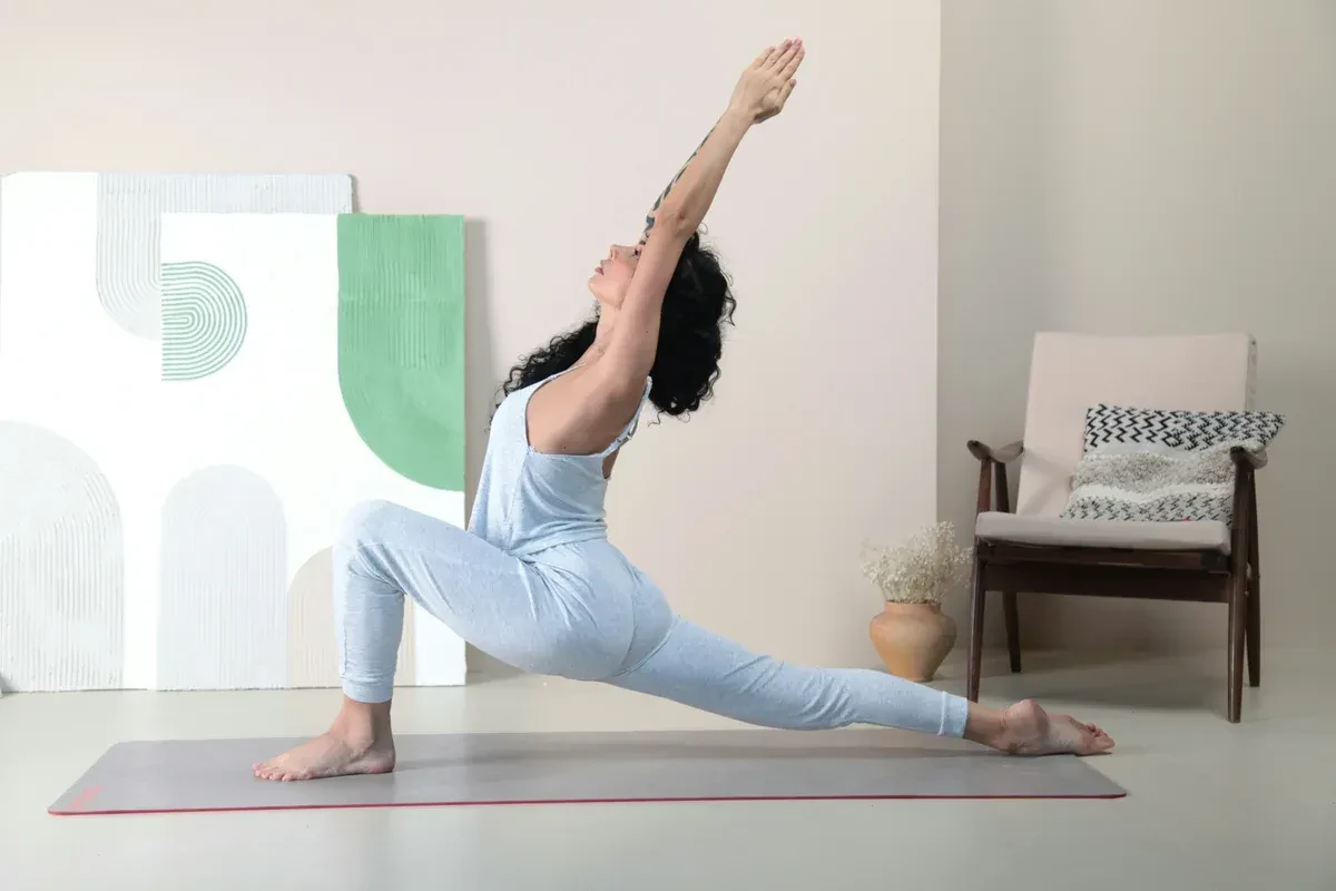 Woman stretching at home on a yoga mat