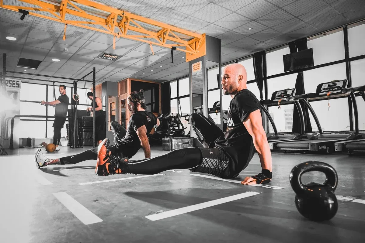 Two male athletes workout out in a gym